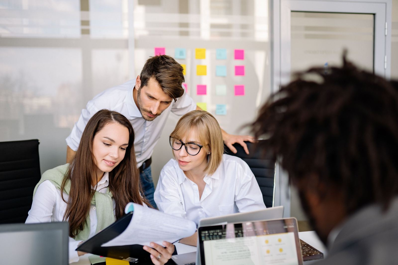 Colleagues reviewing documents together in an office